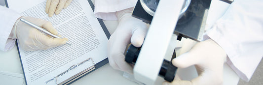 people wearing white latex gloves in a laboratory