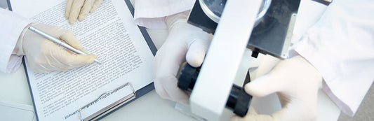 people wearing white latex gloves in a laboratory