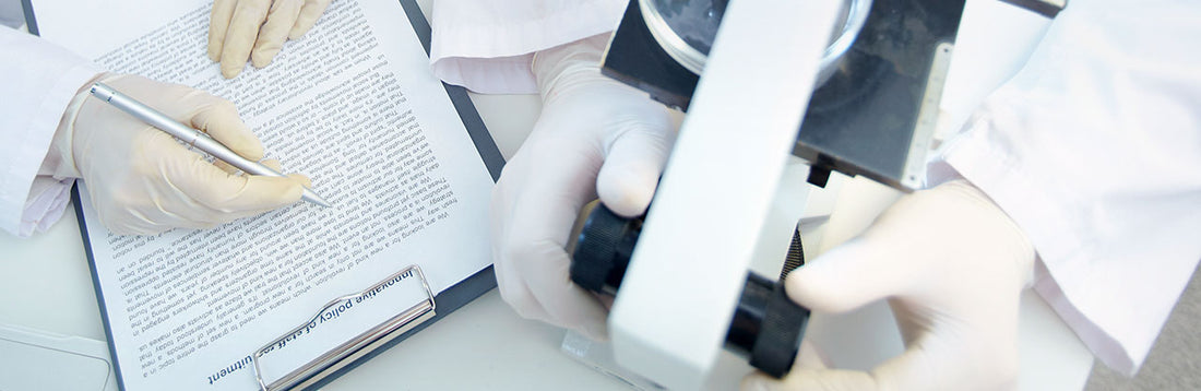 people wearing white latex gloves in a laboratory