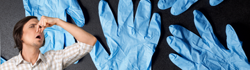 blue nitrile gloves in the background with a guy plugging his nose in front