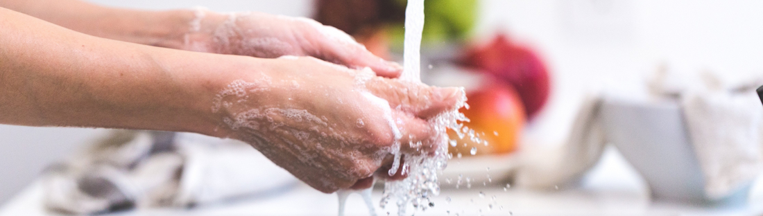 person washing their hands in the kitchen