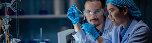 person wearing blue gloves and measuring liquids