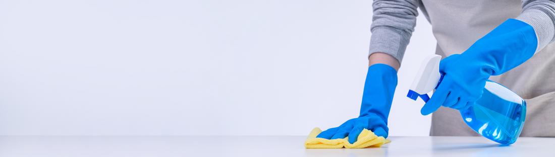 person wearing blue latex gloves and cleaning