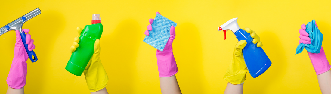 5 hands with pink and yellow gloves holding cleaning supplies