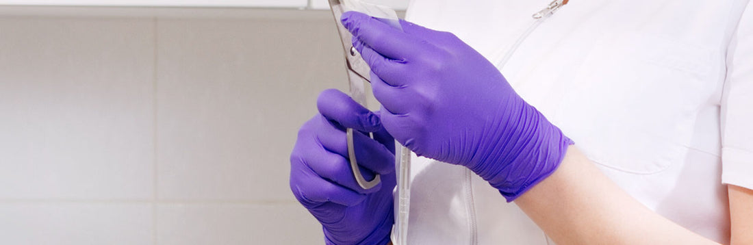 Person wearing grape grip nitrile gloves in a medical setting