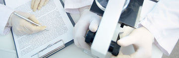 people wearing white latex gloves in a laboratory