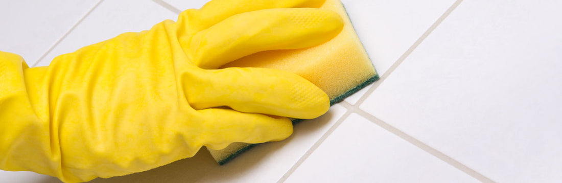 Person wearing yellow neptune gloves and cleaning with a sponge