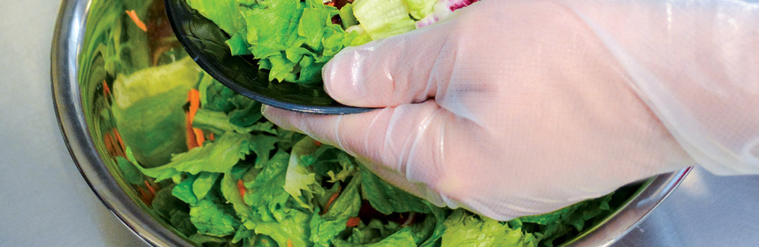Person wearing hybrid gloves and assembling a salad