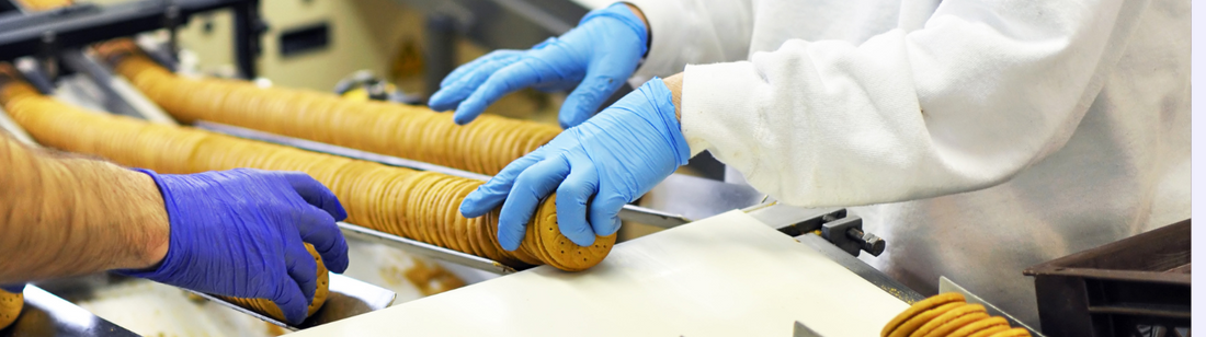 People wearing nitrile gloves and working in a cookie factory