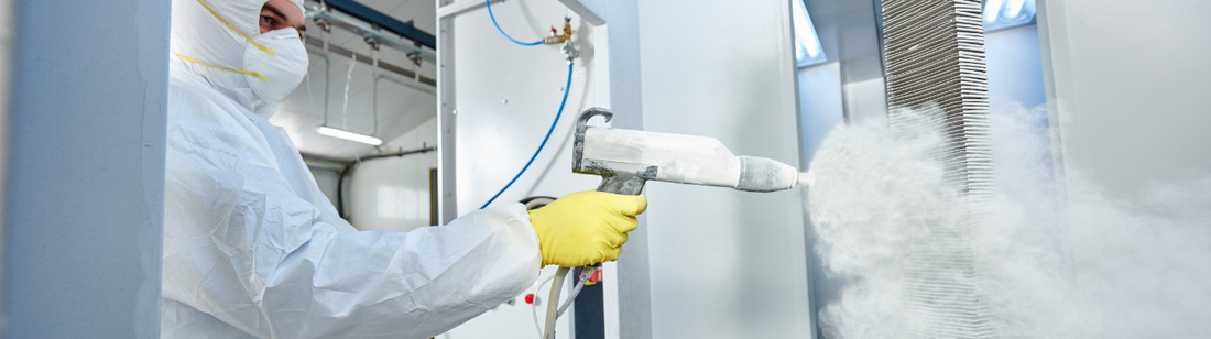 Person doing industrial work while wearing yellow latex gloves